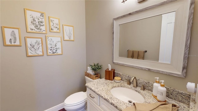 half bathroom with toilet and vanity