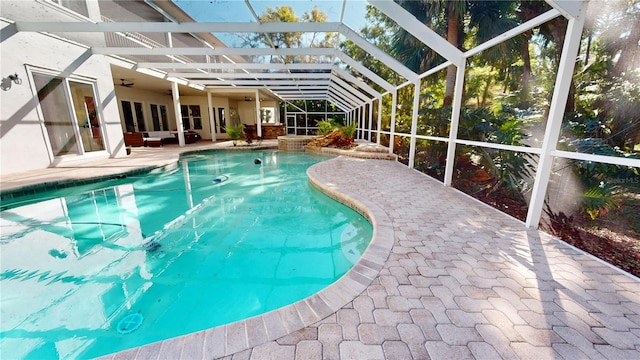 pool with a patio, a lanai, and a ceiling fan