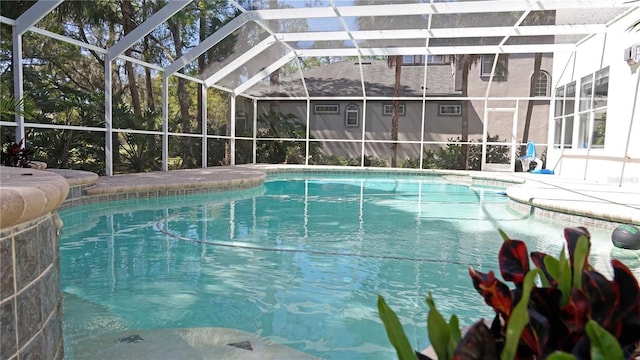 outdoor pool featuring glass enclosure