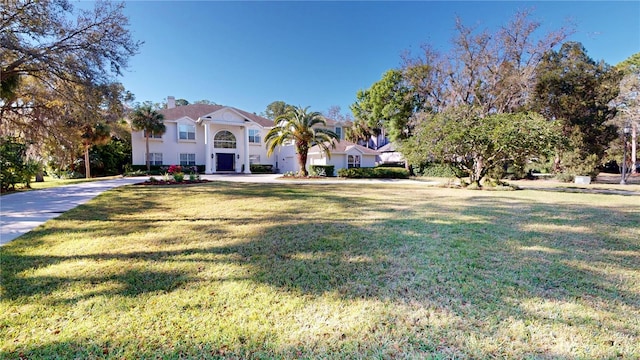 mediterranean / spanish-style house with a chimney and a front yard