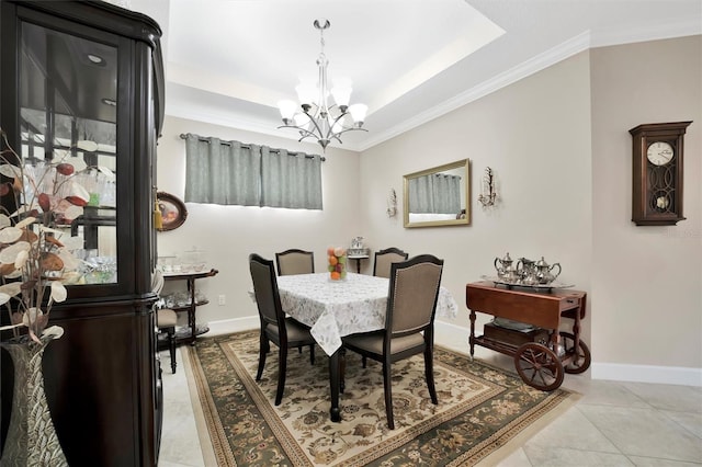 dining space with light tile patterned flooring, a notable chandelier, baseboards, and a tray ceiling