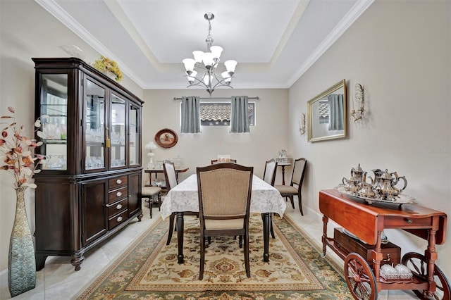 dining area featuring a raised ceiling, an inviting chandelier, crown molding, light tile patterned floors, and baseboards