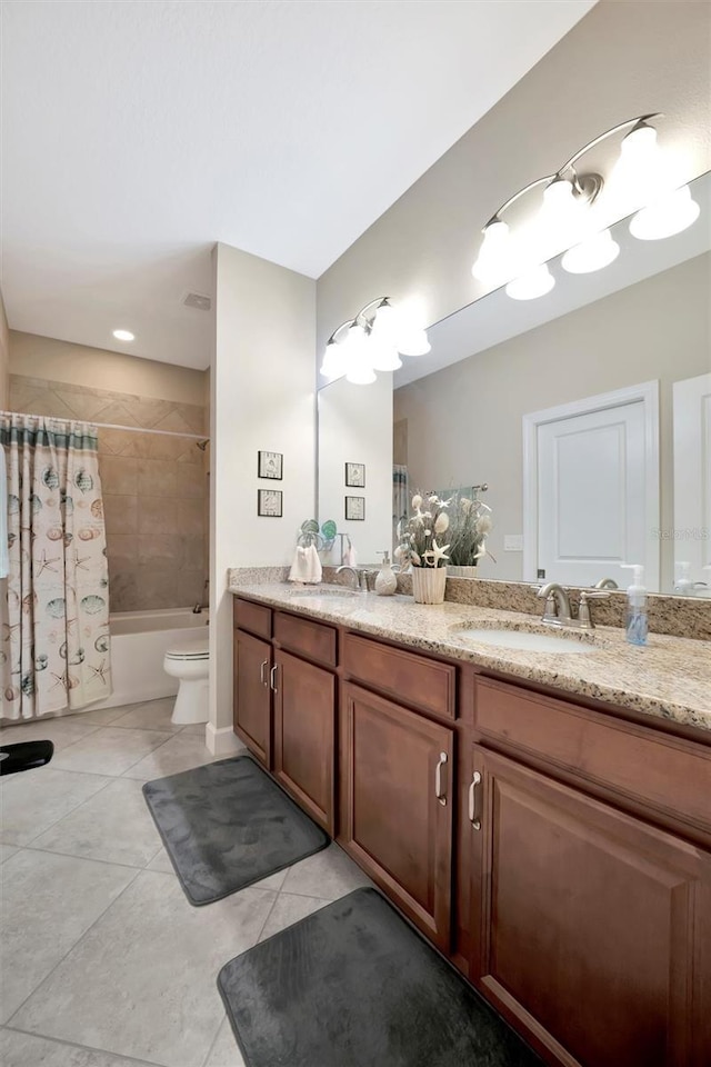 bathroom featuring tile patterned floors, shower / bathtub combination with curtain, toilet, and a sink