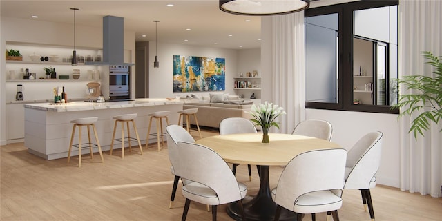 dining room featuring recessed lighting and light wood-style flooring