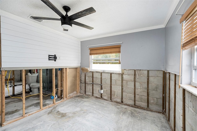 empty room featuring visible vents, a textured ceiling, ceiling fan, and ornamental molding