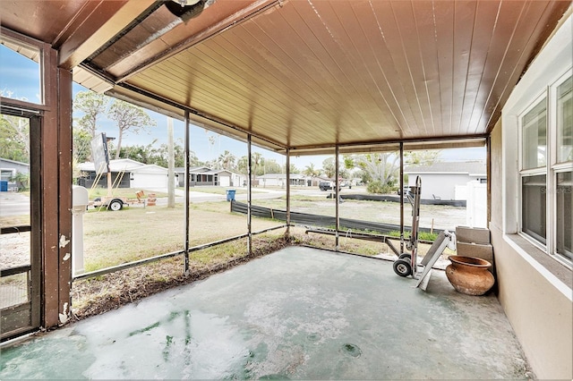 unfurnished sunroom featuring wood ceiling