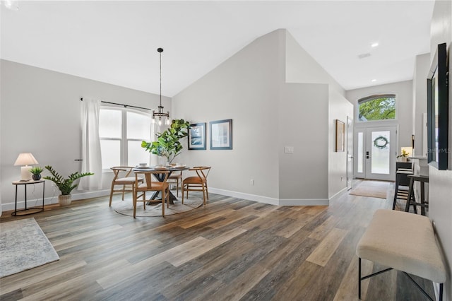 dining space featuring recessed lighting, high vaulted ceiling, baseboards, and wood finished floors