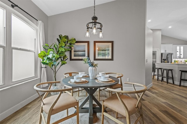 dining space featuring recessed lighting, baseboards, vaulted ceiling, and light wood finished floors