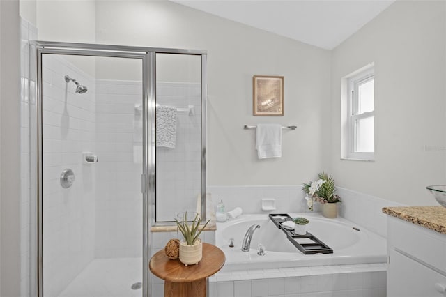 bathroom featuring vanity, a garden tub, and a stall shower