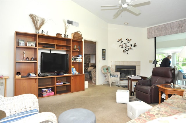 living room featuring a fireplace, carpet, visible vents, and a ceiling fan