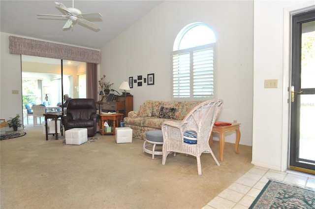 living area featuring a wealth of natural light, light tile patterned floors, high vaulted ceiling, and ceiling fan