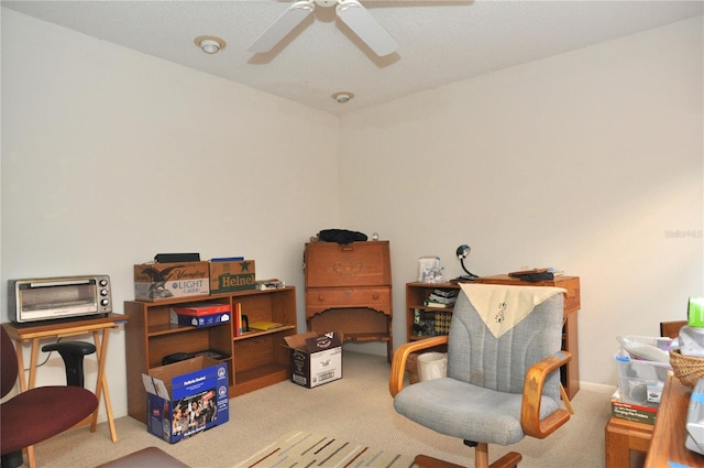 sitting room with carpet flooring and a ceiling fan