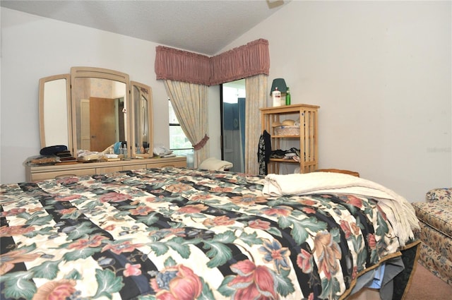 bedroom featuring a textured ceiling and vaulted ceiling