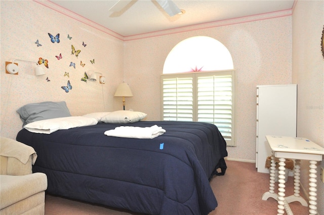 bedroom with wallpapered walls, a ceiling fan, carpet floors, and ornamental molding