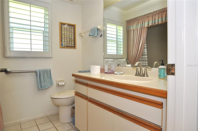 bathroom featuring tile patterned floors, toilet, vanity, and baseboards