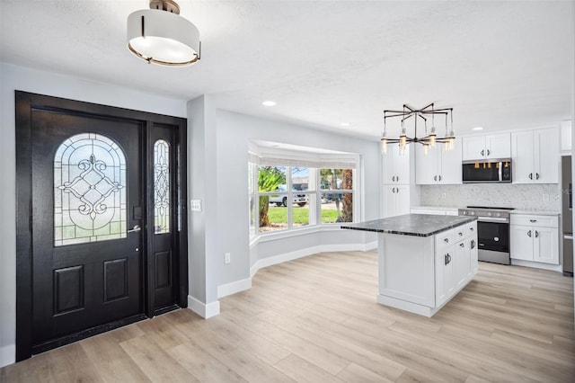 6410 3rd Palm Pt, St Pete Beach, FL 33706 - entrance foyer with recessed lighting, an inviting chandelier, light wood finished floors, and baseboards