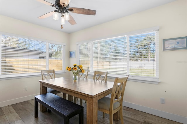 dining area featuring baseboards, wood finished floors, and a ceiling fan