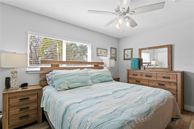 bedroom with a ceiling fan and wood finished floors