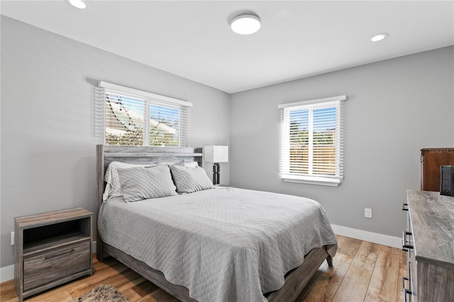 bedroom featuring recessed lighting, baseboards, and light wood finished floors