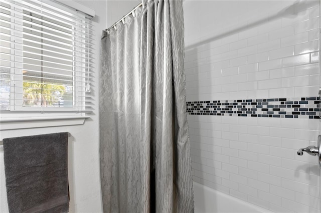 bathroom featuring shower / bath combo with shower curtain