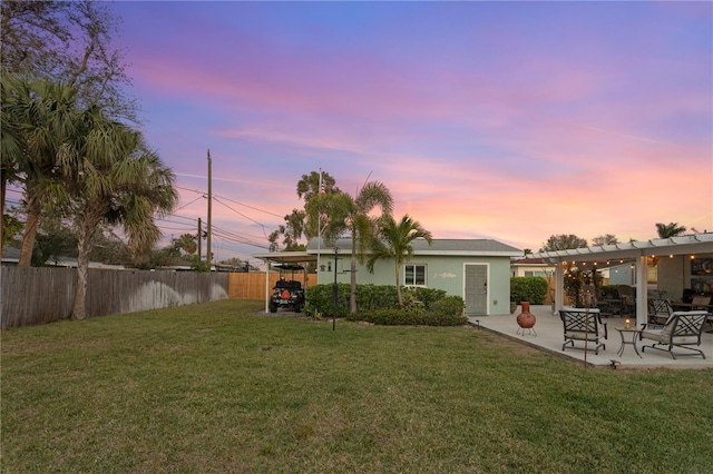 view of yard featuring a patio area, a fenced backyard, and a pergola