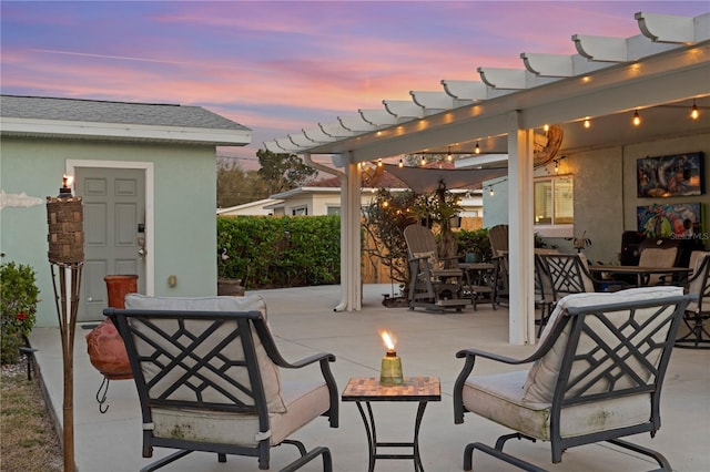 patio terrace at dusk featuring an outdoor living space