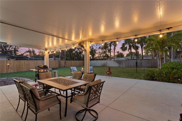 view of patio featuring area for grilling, outdoor dining area, and a fenced backyard