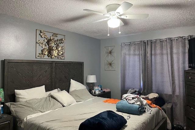 bedroom with a textured ceiling and a ceiling fan