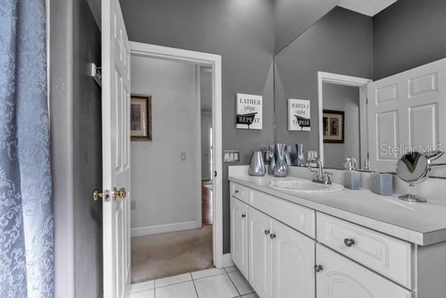 bathroom featuring vanity, tile patterned floors, and baseboards