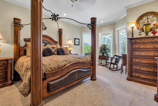 bedroom featuring recessed lighting, carpet floors, ornamental molding, and a ceiling fan