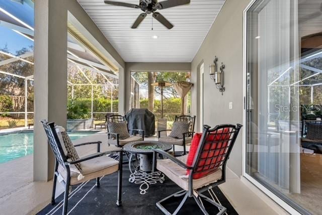 sunroom / solarium featuring a ceiling fan