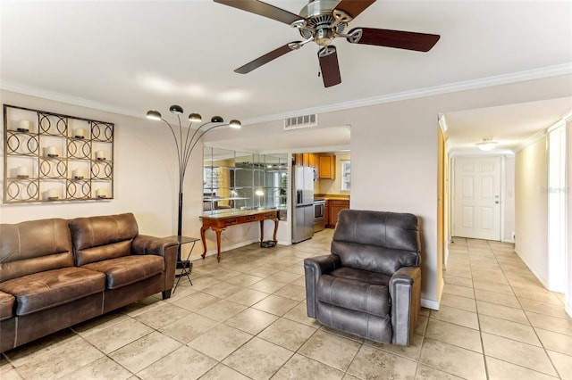 living room featuring visible vents, light tile patterned flooring, crown molding, baseboards, and ceiling fan