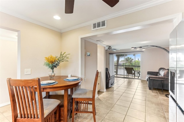 dining space with visible vents, crown molding, baseboards, light tile patterned floors, and a ceiling fan