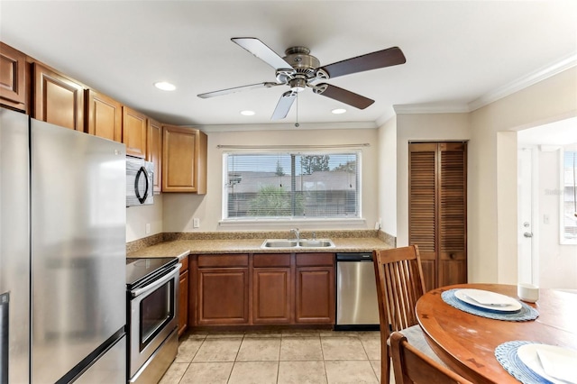 kitchen with light tile patterned flooring, recessed lighting, a sink, ornamental molding, and stainless steel appliances