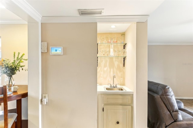 bathroom with visible vents, vanity, and crown molding