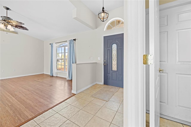 foyer featuring light wood-type flooring, baseboards, and ceiling fan