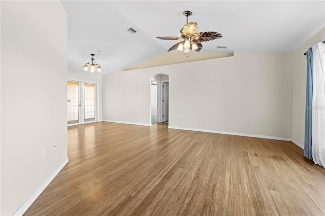 spare room featuring visible vents, baseboards, light wood-style floors, and ceiling fan with notable chandelier