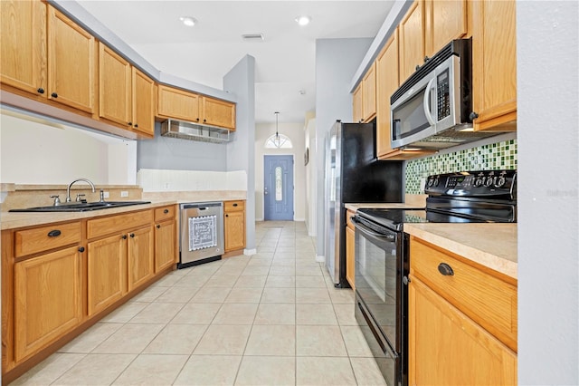 kitchen with visible vents, backsplash, light countertops, appliances with stainless steel finishes, and a sink