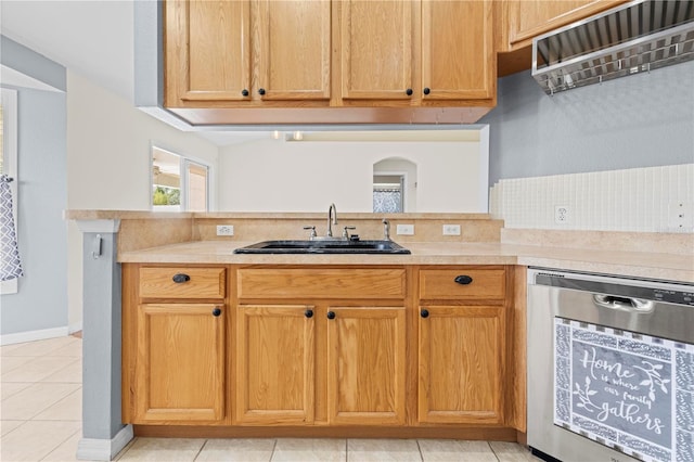 kitchen featuring a sink, beverage cooler, light countertops, light tile patterned floors, and stainless steel dishwasher