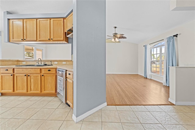 kitchen featuring a ceiling fan, light tile patterned flooring, a sink, light countertops, and stainless steel dishwasher