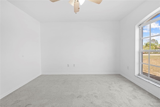 unfurnished room with carpet floors, baseboards, a wealth of natural light, and ceiling fan