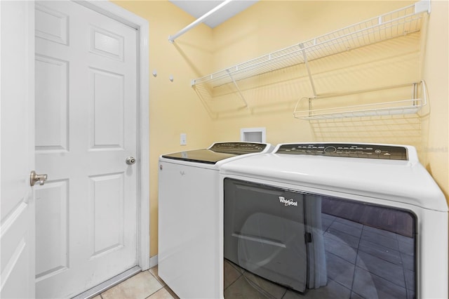 laundry area with light tile patterned floors, laundry area, and washer and dryer