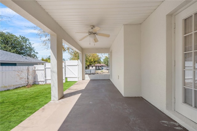 view of patio / terrace with a gate, fence, and ceiling fan