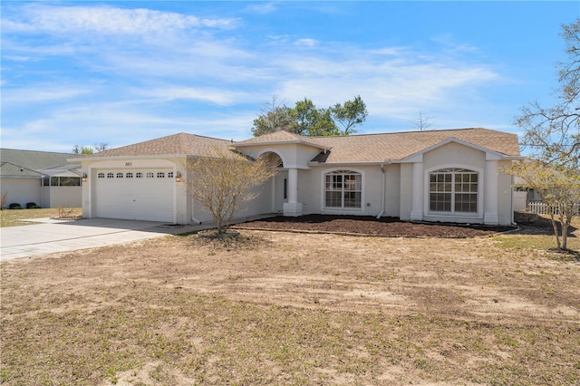 view of front of home with stucco siding, roof with shingles, concrete driveway, and an attached garage