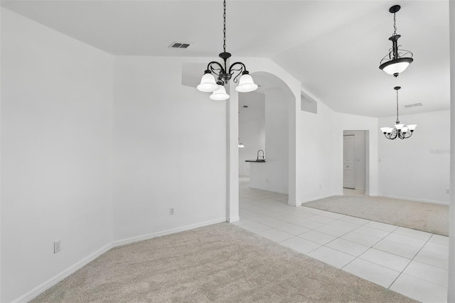 interior space with light tile patterned flooring, visible vents, light colored carpet, and an inviting chandelier