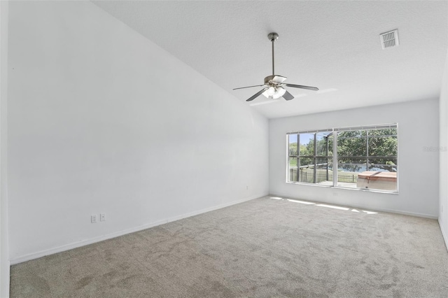 unfurnished room featuring visible vents, carpet flooring, baseboards, ceiling fan, and vaulted ceiling