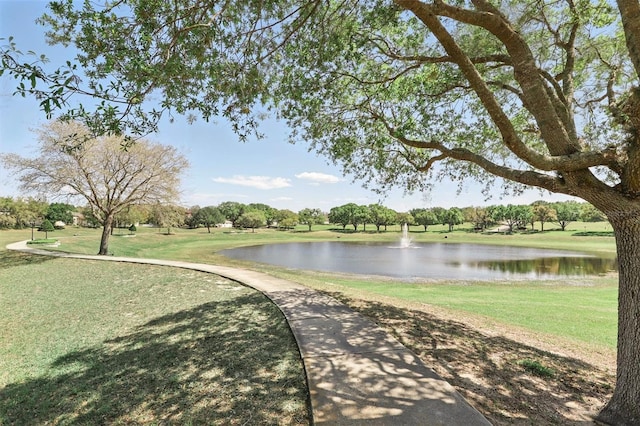 surrounding community featuring a yard and a water view