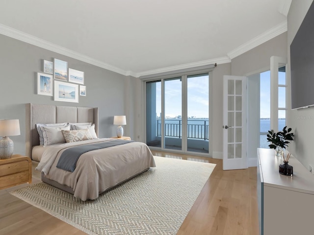 bedroom featuring access to outside, light wood-style floors, and ornamental molding