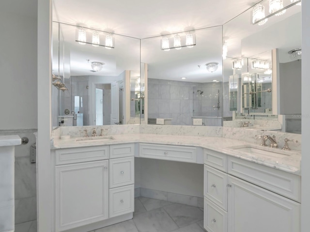 bathroom with double vanity, a stall shower, marble finish floor, and a sink