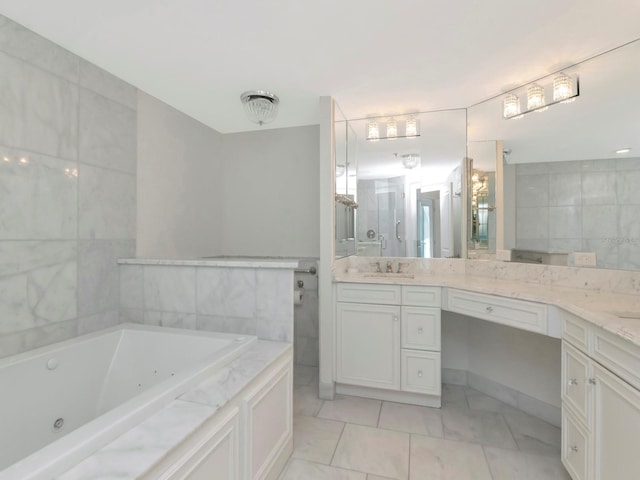 full bath featuring tile walls, a jetted tub, and vanity